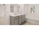 A well lit bathroom with double sinks, large mirror, tub, and shower at 8589 Seabiscuit Rd, Lithonia, GA 30058