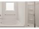 Bright bathroom with a soaking tub and a separate shower with sliding glass doors at 8589 Seabiscuit Rd, Lithonia, GA 30058