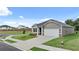 Gray siding one-story house with a two-car garage and landscaped lawn at 8589 Seabiscuit Rd, Lithonia, GA 30058