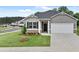 Charming single-story home with well-manicured lawn and attached two car garage at 8589 Seabiscuit Rd, Lithonia, GA 30058