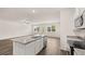 Open floorplan showing the kitchen with a granite island and stainless steel appliances at 8589 Seabiscuit Rd, Lithonia, GA 30058