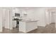 Modern kitchen features white cabinetry, stainless appliances, and an island sink at 8589 Seabiscuit Rd, Lithonia, GA 30058
