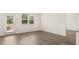 Open living space with wood floors, windows, and door to the backyard at 8589 Seabiscuit Rd, Lithonia, GA 30058
