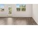 Bright living room with wood floors, natural light, and a door to the outside at 8589 Seabiscuit Rd, Lithonia, GA 30058
