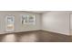 Bright living room featuring wood flooring, a window view, and a door to the outside at 8589 Seabiscuit Rd, Lithonia, GA 30058
