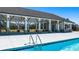 Community pool featuring a covered lounging area with ceiling fans and a stone accented outdoor kitchen space at 8589 Seabiscuit Rd, Lithonia, GA 30058
