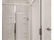 Modern shower with clear glass doors, chrome hardware, and tiled walls at 8589 Seabiscuit Rd, Lithonia, GA 30058