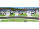 New construction homes on a street with well-maintained lawns and gray exteriors offer modern living at 8589 Seabiscuit Rd, Lithonia, GA 30058