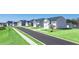 A new construction neighborhood street view with green yards and sidewalks at 8589 Seabiscuit Rd, Lithonia, GA 30058