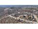 High aerial shot shows a residential neighborhood nestled among trees, showcasing community layout at 1565 Horseshoe Creek Ln, Cumming, GA 30041