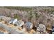 An aerial view of the neighborhood showcases homes with tree-lined streets and beautiful surroundings at 1565 Horseshoe Creek Ln, Cumming, GA 30041