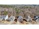 An aerial shot of the neighborhood displays well-maintained homes surrounded by lush greenery and trees at 1565 Horseshoe Creek Ln, Cumming, GA 30041