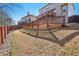 Backyard view showcasing the multi-level deck and fenced perimeter on a sunny day at 1565 Horseshoe Creek Ln, Cumming, GA 30041