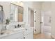 Bathroom with a view to bedroom; featuring a white vanity with stylish granite countertop at 1565 Horseshoe Creek Ln, Cumming, GA 30041