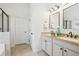 Bright bathroom with double sink vanity with granite counters, tile floor, and a glass-enclosed shower at 1565 Horseshoe Creek Ln, Cumming, GA 30041