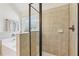 Close-up of glass enclosed shower and tiled soaking tub area with neutral decor at 1565 Horseshoe Creek Ln, Cumming, GA 30041