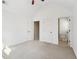 Large carpeted bedroom featuring a ceiling fan and ensuite bathroom at 1565 Horseshoe Creek Ln, Cumming, GA 30041