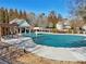 Community pool covered for the off-season, featuring a pergola, picnic tables, and a pool house at 1565 Horseshoe Creek Ln, Cumming, GA 30041