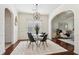 Bright dining area with wood floors, modern light fixture, table and chairs at 1565 Horseshoe Creek Ln, Cumming, GA 30041