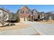 Charming two-story brick home with a well-manicured front yard at 1565 Horseshoe Creek Ln, Cumming, GA 30041