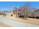 Lovely two-story brick home with a manicured front lawn and two-car garage at 1565 Horseshoe Creek Ln, Cumming, GA 30041