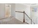 View of open hallway featuring wood and white banister, chandelier, and views of the front entry at 1565 Horseshoe Creek Ln, Cumming, GA 30041