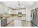 Well-lit kitchen with stainless appliances, granite counters, and island at 1565 Horseshoe Creek Ln, Cumming, GA 30041