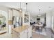 Modern kitchen flowing into dining and living areas, featuring stainless steel appliances and an island at 1565 Horseshoe Creek Ln, Cumming, GA 30041