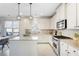 Bright kitchen with stainless steel appliances, island, and tile backsplash at 1565 Horseshoe Creek Ln, Cumming, GA 30041