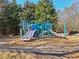 Community playground featuring slides and climbing structures with wood chip ground covering at 1565 Horseshoe Creek Ln, Cumming, GA 30041