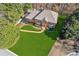 Aerial view of a well-maintained brick home with a lush lawn, a curved brick walkway and mature trees at 3611 Howell Wood Trl, Duluth, GA 30096