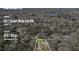 An aerial view of a property in a wooded area, noting its address and lot size at 3611 Howell Wood Trl, Duluth, GA 30096