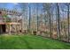 Picture of a backyard with a green lawn and a wooden deck with a pergola at 3611 Howell Wood Trl, Duluth, GA 30096