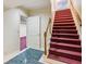 Staircase leading to basement featuring carpeted stairs and colorful flooring at 3611 Howell Wood Trl, Duluth, GA 30096