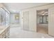 Bathroom with soaking tub next to window, doorway leading into adjoining carpeted room at 3611 Howell Wood Trl, Duluth, GA 30096