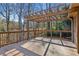 Wooden deck with railings and overhead trellis, overlooking a wooded area at 3611 Howell Wood Trl, Duluth, GA 30096