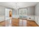 Formal dining room with hardwood floors, a crystal chandelier, and wainscoting detail at 3611 Howell Wood Trl, Duluth, GA 30096