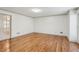 Bright, empty room with light walls, hardwood floors and view of a glass door at 3611 Howell Wood Trl, Duluth, GA 30096