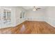 Bright living room with hardwood floors, paneled walls, and glass doors leading to the outdoor patio at 3611 Howell Wood Trl, Duluth, GA 30096