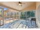 Screened-in porch with ceiling fan and tiled floor offering an outdoor seating area at 3611 Howell Wood Trl, Duluth, GA 30096