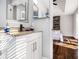 Bright bathroom with granite countertop and white cabinets at 6492 Swift Creek Rd, Lithonia, GA 30058