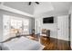 Main bedroom with hardwood floors, bay window, and accent wall at 6492 Swift Creek Rd, Lithonia, GA 30058