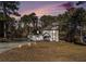 Two-story house exterior at dusk with a two-car garage at 6492 Swift Creek Rd, Lithonia, GA 30058