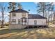 Two-story house with deck, landscaped yard, and satellite dish at 6492 Swift Creek Rd, Lithonia, GA 30058