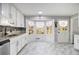 Bright kitchen with white cabinets, stainless steel appliances, and marble flooring at 6492 Swift Creek Rd, Lithonia, GA 30058