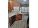 Kitchen with wood cabinets, black appliances, and double sink at 658 Austin Creek Dr, Buford, GA 30518