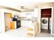Kitchen boasts granite countertops, white cabinets, and laundry access at 12384 Riviera Dr, Fayetteville, GA 30215