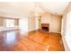 Spacious living room featuring hardwood floors and a brick fireplace at 12384 Riviera Dr, Fayetteville, GA 30215