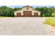 Tan barn with three large brown garage doors at 350 Taylor Path, Dallas, GA 30157