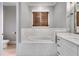 Freestanding bathtub with marble tile and wood shutters at 350 Taylor Path, Dallas, GA 30157